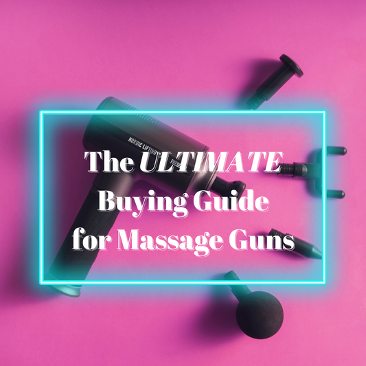 An image of a massage gun with accessories on a pink background