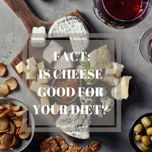 Different kinds of cheese on a wooden chopping board