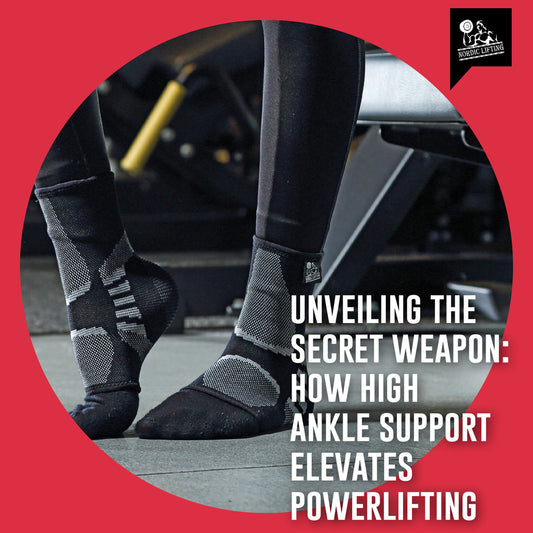 A gym enthusiast shows his feet wearing a black and gray high ankle support.